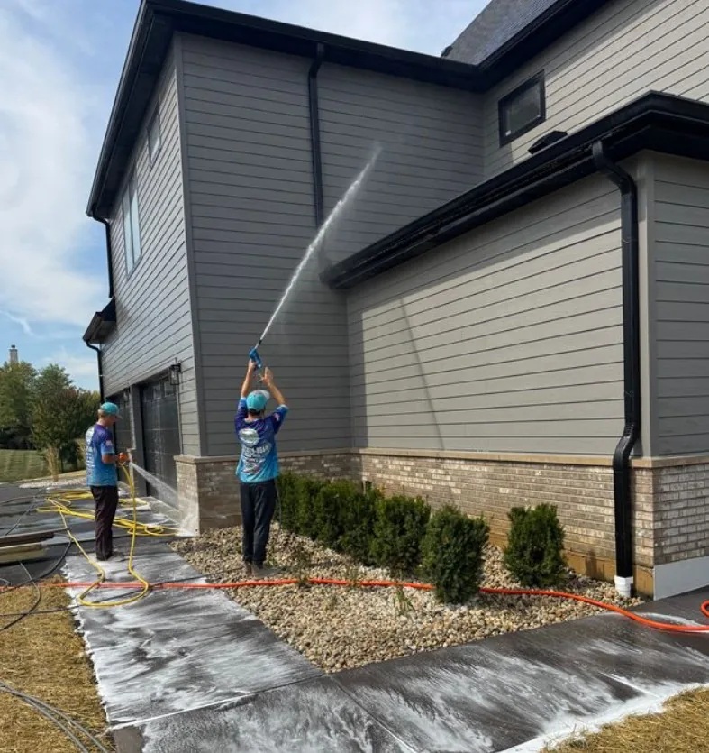 Our crew soft washing a home's siding